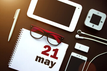 May 21st . Day 21 of month, Calendar date. Office workplace with laptop, notebook, office supplies...