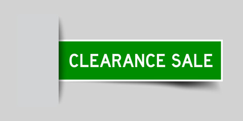 Inserted green color sticker label with word clearance sale on gray background