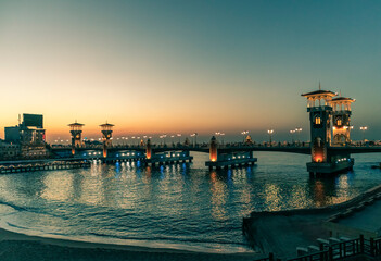 Stanley bridge at Alexandria with orange and teal sunset sky and sea with beach