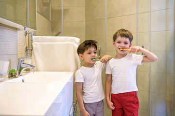 Fototapeta premium Two brothers brush my teeth in the bathroom.The beginning of a new day