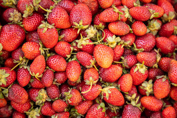 Fresh organic strawberry background. Closeup at the berries on a market.