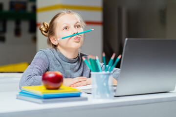 two naughty little Indian girls holding a pencil like a mustache. standing isolated on white...