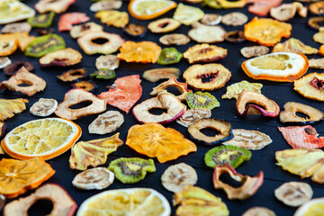 Organic Healthy Assorted Dried Fruit Mix close up. Dried fruit snacks. dried apples, mango, feijoa, dried apricots, prunes top view