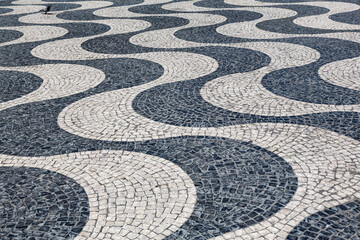 Characteristic wave pattern of cobblestone pavement on Rossio square, Lisbon, Portugal
