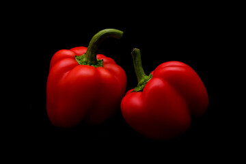 Two bell peppers on dark background