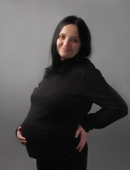 Pregnant woman on a gray background