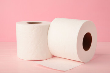 Toilet paper close-up on pink background with copy space