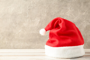 Single Santa Claus red hat on grey background.