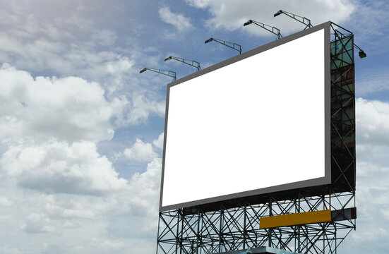 blank canvas billboard white screen design for display advertising banner outdoor. large mockup ad banner with blue sky and cloud.
