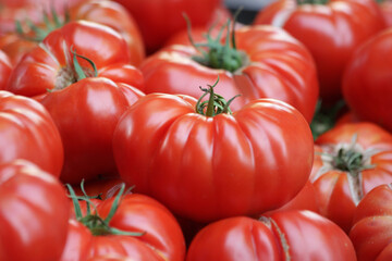 Fresh big red tomatoes close up. Organic juicy vegetables. Healthy eating concept.