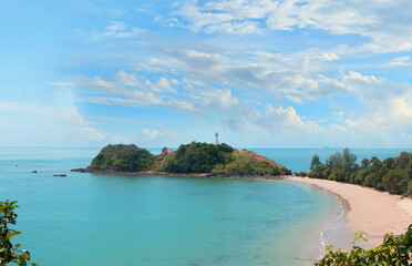 Fototapeta premium The lighthouse on the island and the blue sky taken from above