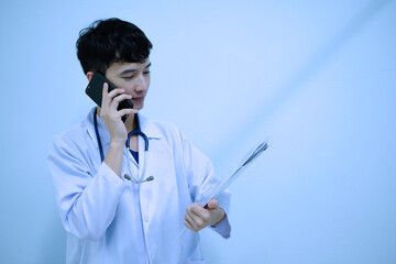 A male doctor talking telephone and holding document file