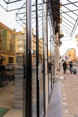 Fototapeta premium Closed Store due to Coronavirus pandemic. Locked Store Door with Padlock. Selective focus on the padlock