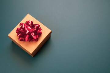 Festive copy space background with gift box made from craft paper with red bow