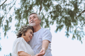 Fototapeta premium Happy asian senior retired couple, relax smiling elder man and woman enjoying with retired vacation at sea beach outdoor. Health care, Family outdoor lifestyle