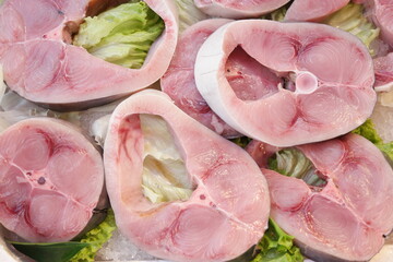 Mackerel fish steaks close up. Fresh raw fish slices on counter at supermarket.