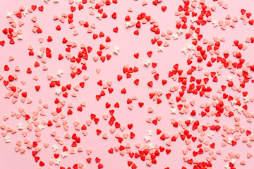 sprinkles background, sugar sprinkle red hearts, decoration for cake and bakery. Top view, flat lay. Valentines holiday