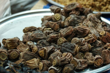 Pile of dried figs close up. Heap of natural dried fruits at market counter. Organic food concept.