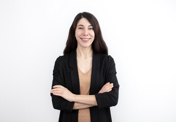 Smiling confident business woman posing with folded arms. Happy business woman in formal suit standing for camera on white studio background. Corporate portrait concept.
