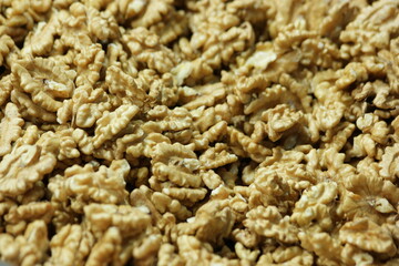 Peeled walnuts background. Pile of raw organic walnuts close up. Healthy nutritious product.