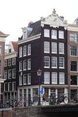 Street View in Amsterdam with Old Houses and Bridge