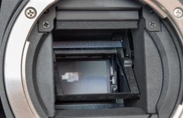 The mirror of digital Camera APS-C and lens mount , close-up. The detail of open digital mirrorless...