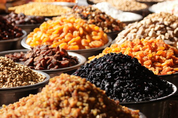 Variety of dried fruits on the market counter. Assorted dried fruits on display at farmers market.