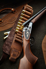 Classic trigger double-barreled hunting rifle on a green background. Smooth-bore hunting rifle open...