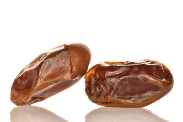 Several dried dates, close-up, isolated on white.