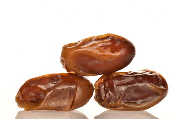 Several dried dates, close-up, isolated on white.