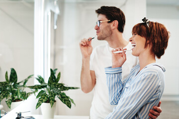 Couple brushing their teeth in the bathroom