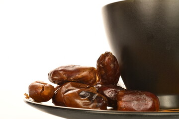 Several dried dates, close-up, isolated on white.