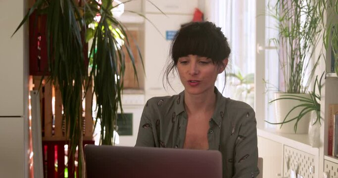 Brunette woman but having trouble while video call through computer at home