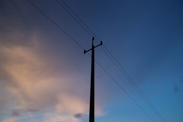 Power lines against the background of the evening sky.