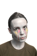 Woman with different colors of tears on a white background. Creative make-up.