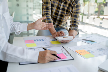 Startup business people teamwork calculating a valuation in workplace..