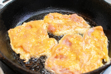 Cooking the chop in a pan. Chicken meat in batter.