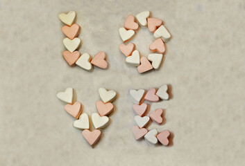 Fototapeta na wymiar background the word love from white and pink marshmallows Valentine's day