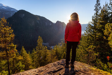 Adventurous Girl Hiking in the mountains during a sunny Autumn Sunset. Taken Squamish, North of Vancouver, British Columbia, Canada. Concept: Adventure, freedom, lifestyle