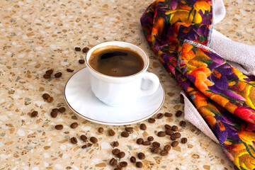 A cup of freshly brewed coffee on the kitchen table.