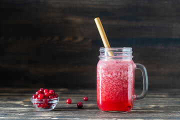 Cranberry and cowberry smoothie in mason jar with bamboo straw. Refreshing summer fruit drink. The concept of healthy eating. Copy space