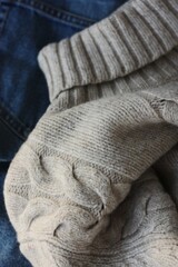 Beige knit sweater and blue jeans 