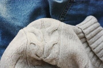 Beige knit sweater and blue jeans 