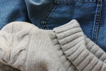 Beige knit sweater and blue jeans 