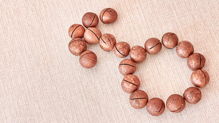 The gender sign indicating the female body is laid out of macadamia nuts.