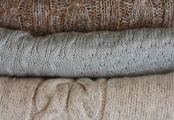 Fototapeta na wymiar Grey beige and brown sweaters close up