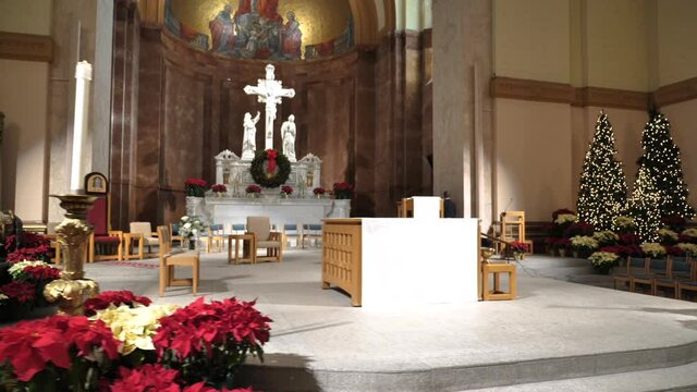 Altar of Catholic Church With Wedding Bouquets and Christmas Trees, Slow Motion. St Peter and Paul Cathedral, Indianapolis USA