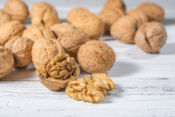 Walnuts kernels on white wooden desk, stock photo