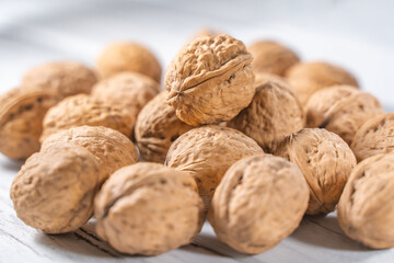 Walnuts kernels on white wooden desk, stock photo