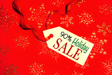 Label with the text - Holiday sale with a 90 percent discount, on a decorated Christmas background,...